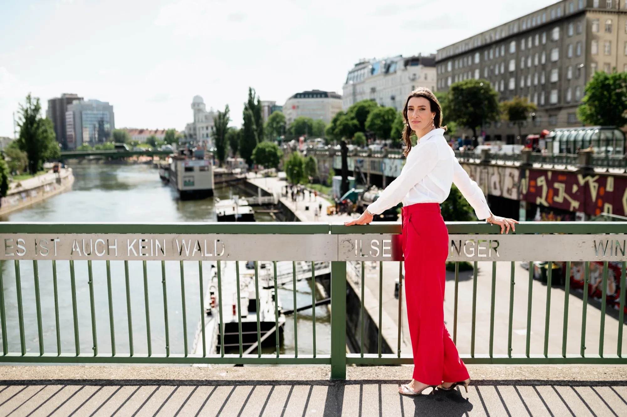 A woman walking across a bridge
